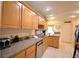 Kitchen with wood cabinets, granite countertops, and stainless steel appliances at 135 Mi Rancho Rd, Davenport, FL 33837