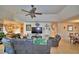 Open living room with sectional sofa and large TV at 135 Mi Rancho Rd, Davenport, FL 33837