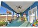 Relaxing screened porch with rocking chairs and patio furniture at 135 Mi Rancho Rd, Davenport, FL 33837