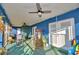 Relaxing screened porch with ceiling fans, rocking chairs, and room for outdoor furniture at 135 Mi Rancho Rd, Davenport, FL 33837