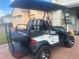 Rear view of a white golf cart with added cargo space at 1402 Colonial Ct, Winter Haven, FL 33884