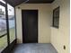 Screened-in back porch with tiled floor and black exterior door at 16 Kendra Ct # 16, Winter Haven, FL 33880