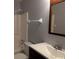 Bathroom with shower/tub combo, vanity, and a wood-framed mirror at 16 Kendra Ct # 16, Winter Haven, FL 33880