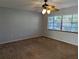 Spacious bedroom with neutral walls, carpeting, and ceiling fan at 16 Kendra Ct # 16, Winter Haven, FL 33880