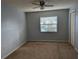 Bright bedroom with neutral walls, carpeting, and a ceiling fan at 16 Kendra Ct # 16, Winter Haven, FL 33880
