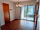 Dining room with wood-look flooring, chandelier, and sliding glass doors at 16 Kendra Ct # 16, Winter Haven, FL 33880