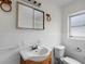 Bathroom with wood vanity and tiled walls at 1891 18Th Nw St, Winter Haven, FL 33881