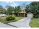 House with a large front yard, driveway, and mature trees at 1891 18Th Nw St, Winter Haven, FL 33881