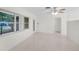 Living room with large windows, terrazzo floors, and a door at 1891 18Th Nw St, Winter Haven, FL 33881
