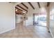 Dining room with tile floors, exposed beams, and view of the kitchen at 1988 13Th Nw St, Winter Haven, FL 33881