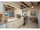 Bright kitchen featuring white cabinetry, stainless steel appliances, and a view of the dining area at 1988 13Th Nw St, Winter Haven, FL 33881