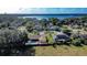 An aerial view showcasing the property, pool, and proximity to a nearby lake at 218 College Grove Ne Cir, Winter Haven, FL 33881
