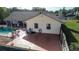 Backyard view highlighting the in-ground pool, patio, and fenced perimeter at 218 College Grove Ne Cir, Winter Haven, FL 33881