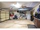 Garage space with storage shelves, overhead kayak rack, and workshop counter area at 218 College Grove Ne Cir, Winter Haven, FL 33881