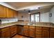 Kitchen with breakfast bar, stainless steel dishwasher, wood cabinets, and recessed lighting at 218 College Grove Ne Cir, Winter Haven, FL 33881
