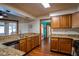 Open-concept kitchen with granite counters, wood cabinets, and breakfast bar at 218 College Grove Ne Cir, Winter Haven, FL 33881