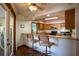 Kitchen's breakfast bar with seating, overlooking the backyard and pool area at 218 College Grove Ne Cir, Winter Haven, FL 33881