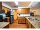 Spacious kitchen with granite countertops, stainless steel appliances, and ample cabinetry at 218 College Grove Ne Cir, Winter Haven, FL 33881