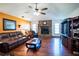 Living room featuring a stone fireplace, wood floors, and comfortable seating at 218 College Grove Ne Cir, Winter Haven, FL 33881