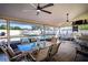 Covered patio area with a dining table and view of the in-ground pool at 218 College Grove Ne Cir, Winter Haven, FL 33881