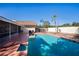 Backyard oasis featuring a sparkling pool, spa, and spacious patio area at 218 College Grove Ne Cir, Winter Haven, FL 33881
