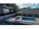 Aerial view of in-ground pool, screen enclosure and surrounding yard at 218 College Grove Ne Cir, Winter Haven, FL 33881
