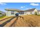 Backyard with a screened porch, grill, and dry grass under a blue sky at 221 Prather Dr, Davenport, FL 33837