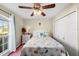 Guest bedroom with wood floors, ceiling fan, and queen bed with coastal decor at 221 Prather Dr, Davenport, FL 33837