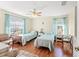 Bedroom with two twin beds, light teal bedding, and wood-look floors at 221 Prather Dr, Davenport, FL 33837