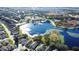 Aerial view of the community showcasing a lake, clubhouse, and homes at 221 Prather Dr, Davenport, FL 33837