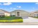 Charming green one-story home with a welcoming front porch and attached two-car garage at 221 Prather Dr, Davenport, FL 33837