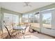 Bright Florida room with tile floor, table and chairs, and backyard view at 221 Prather Dr, Davenport, FL 33837