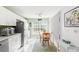 Bright eat-in kitchen with white cabinets, stainless steel appliances, and a dining area at 221 Prather Dr, Davenport, FL 33837