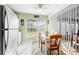 Kitchen nook with dinette set, green accents, white appliances, and window view at 221 Prather Dr, Davenport, FL 33837