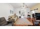 Cozy living room with wood floors, ceiling fan, and sliding barn door at 221 Prather Dr, Davenport, FL 33837