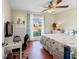 Primary bedroom with queen bed, white furniture, and a large window at 221 Prather Dr, Davenport, FL 33837