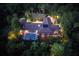 Night aerial view of house, pool, and lush landscaping at 2300 N Scenic Hwy # 104, Lake Wales, FL 33898