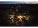 Stunning nighttime aerial view of a home with beautifully lit landscaping at 2300 N Scenic Hwy # 104, Lake Wales, FL 33898