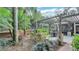 Relaxing backyard patio with pergola, built-in grill, and dining area at 2300 N Scenic Hwy # 104, Lake Wales, FL 33898
