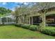 Expansive backyard with lush landscaping, pool, and screened patio at 2300 N Scenic Hwy # 104, Lake Wales, FL 33898