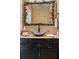 Upscale bathroom boasts dark vanity, copper vessel sink, and ornate mirror at 2300 N Scenic Hwy # 104, Lake Wales, FL 33898
