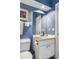 Small bathroom with white vanity and blue walls at 2300 N Scenic Hwy # 104, Lake Wales, FL 33898