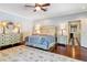 Main bedroom with king-size bed, hardwood floors, and access to en-suite bathroom at 2300 N Scenic Hwy # 104, Lake Wales, FL 33898
