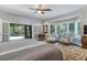 Main bedroom with king-size bed, sitting area, and access to a private patio at 2300 N Scenic Hwy # 104, Lake Wales, FL 33898