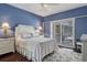 Bedroom with white bedding, blue walls, and access to a private patio at 2300 N Scenic Hwy # 104, Lake Wales, FL 33898