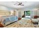 Main bedroom with king-size bed, access to a private patio, and hardwood floors at 2300 N Scenic Hwy # 104, Lake Wales, FL 33898