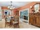 Bright dining room features a glass table, rattan chairs, and access to the kitchen at 2300 N Scenic Hwy # 104, Lake Wales, FL 33898