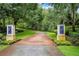 Brick driveway entrance with lush landscaping and elegant lighting at 2300 N Scenic Hwy # 104, Lake Wales, FL 33898