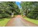 Landscaped entryway with a brick driveway leading to a luxurious home at 2300 N Scenic Hwy # 104, Lake Wales, FL 33898