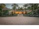 Elegant home with a brick driveway and palm trees at dusk at 2300 N Scenic Hwy # 104, Lake Wales, FL 33898